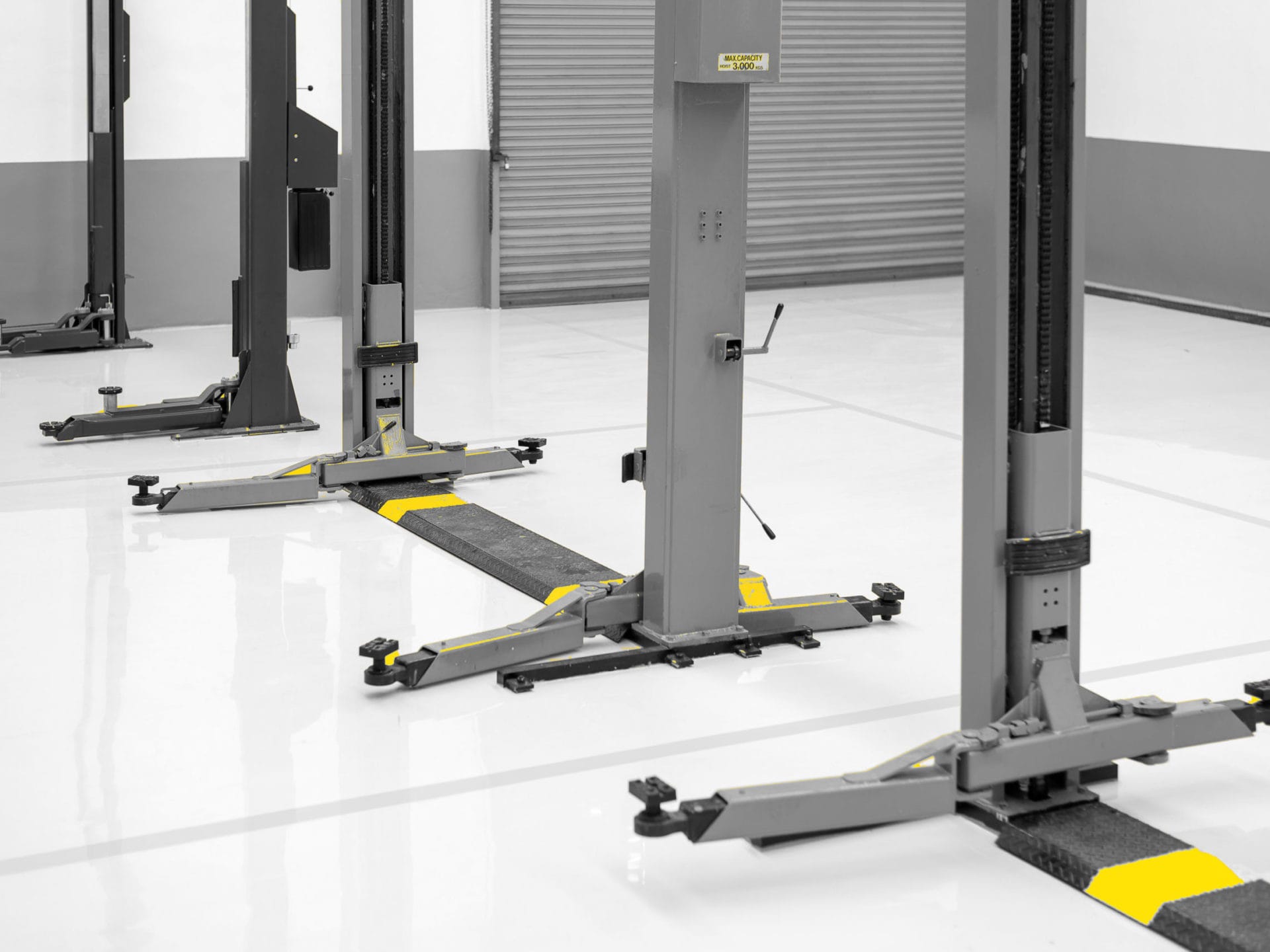 New car repair station with soft-focus in the background and over light,interior car-care center. The electric lift for cars in the service.